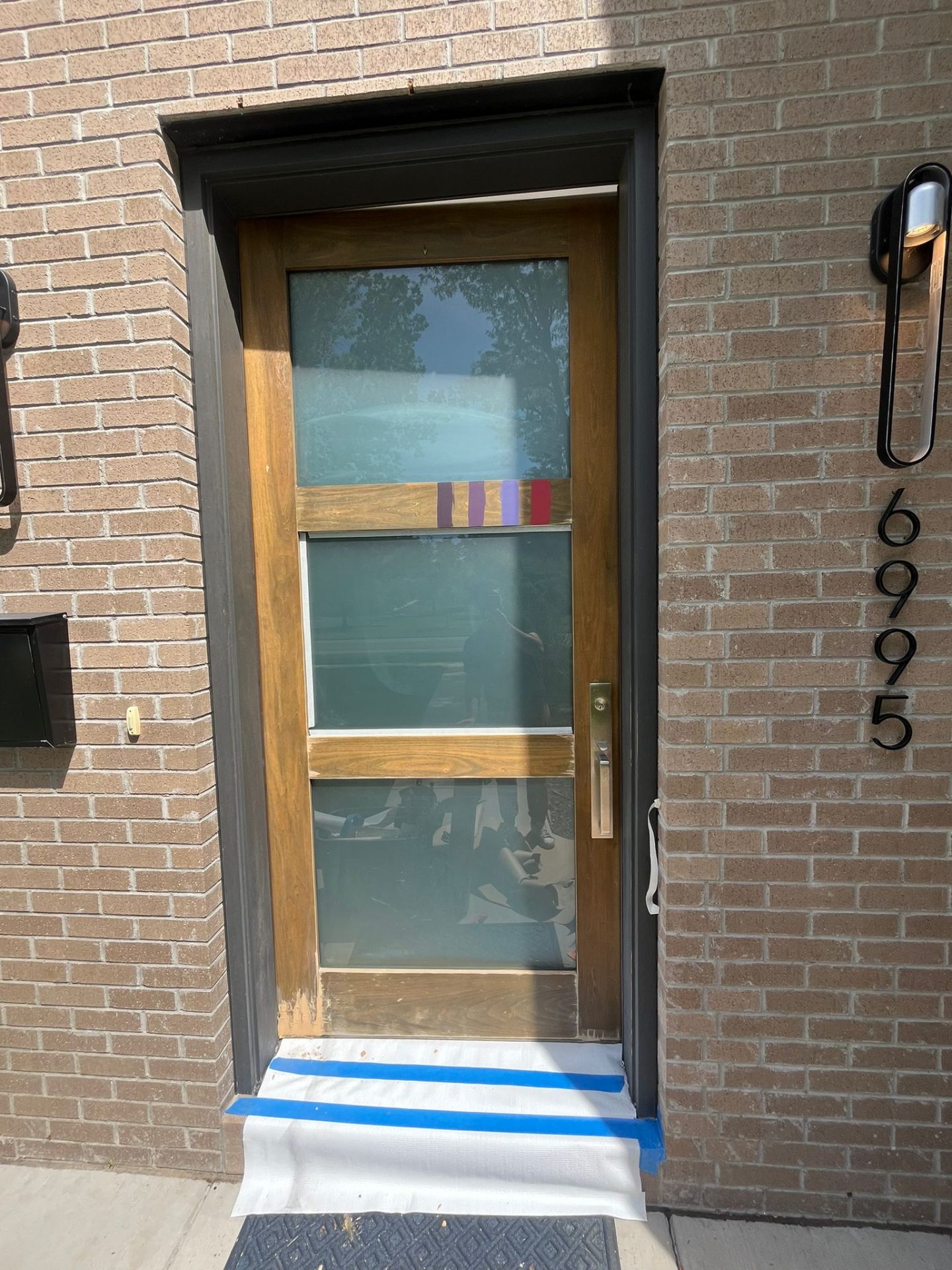 Modern 3-panel wood front door before refinishing — AZ Handyman