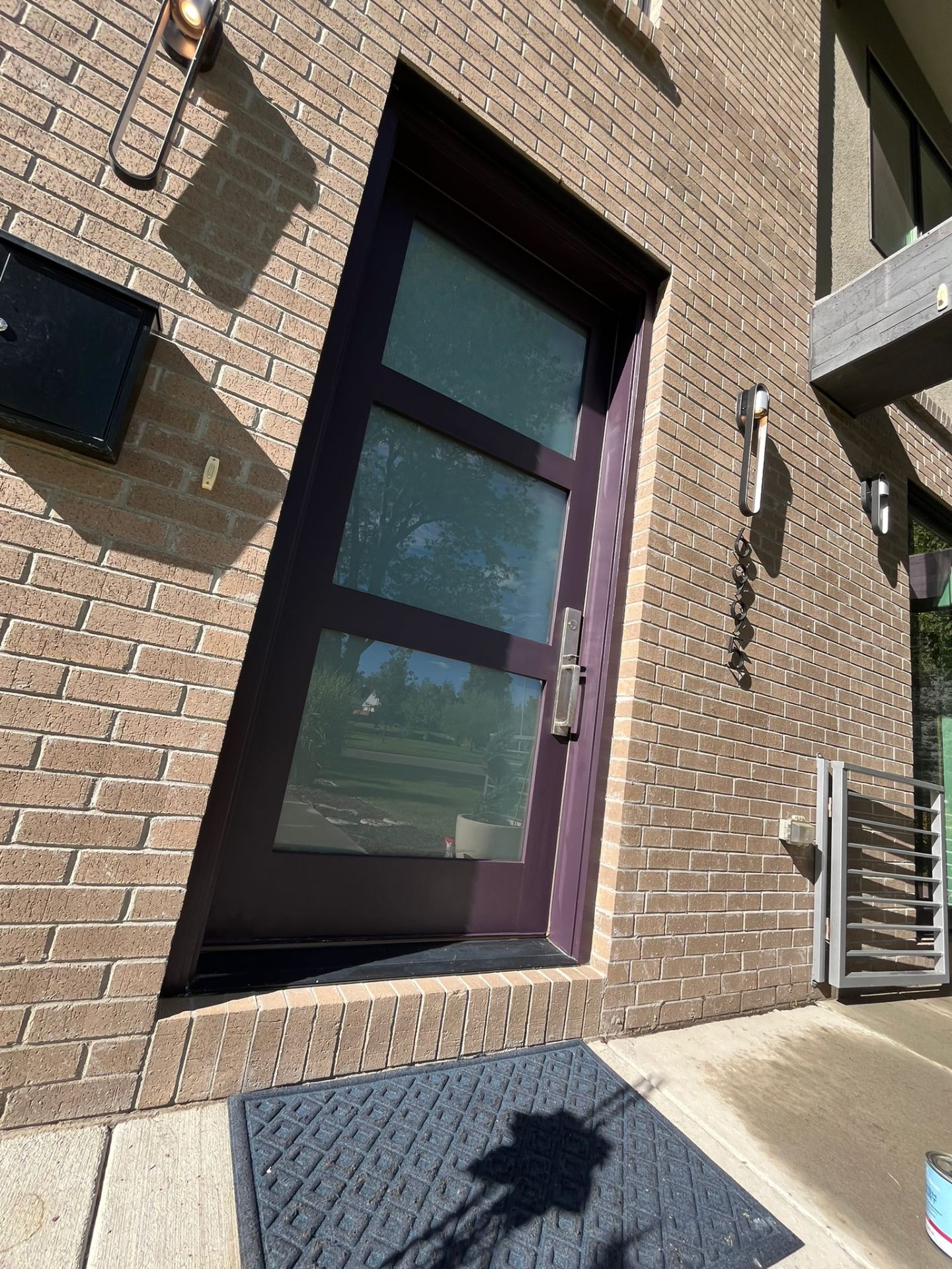 Refinished modern front door, glossy plum finish — angled view
